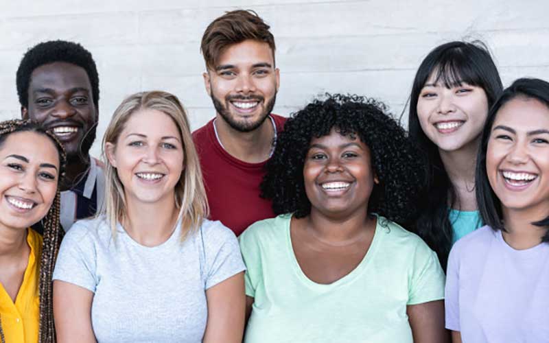 7 people, 3 in back and 4 in front. White, Asian, Latino, African American skin tones. In an article on how far back someone can trace their ancestry.