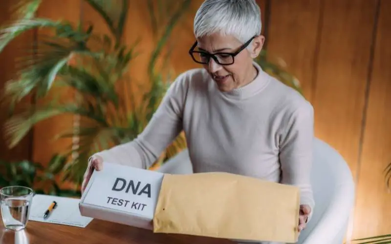 woman taking out the dna test kit from the package