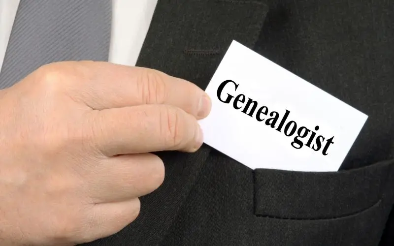 a man taking out a white card from his pocketwith the text genealogist