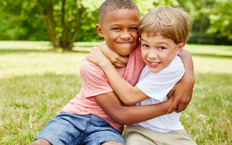 Photo of two young boys hugging each other