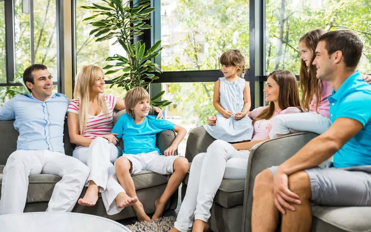 Photo showing two families in living room