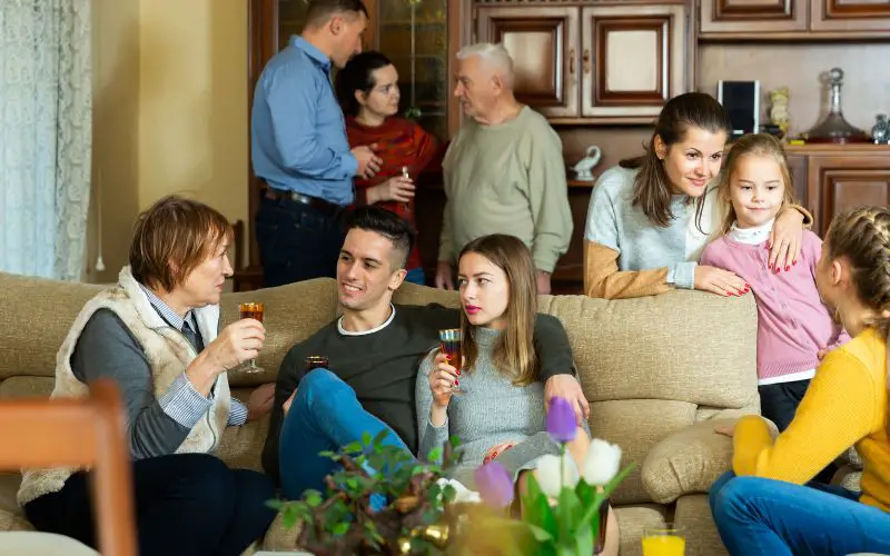 Photo showing a group of people inside a house talking to each other