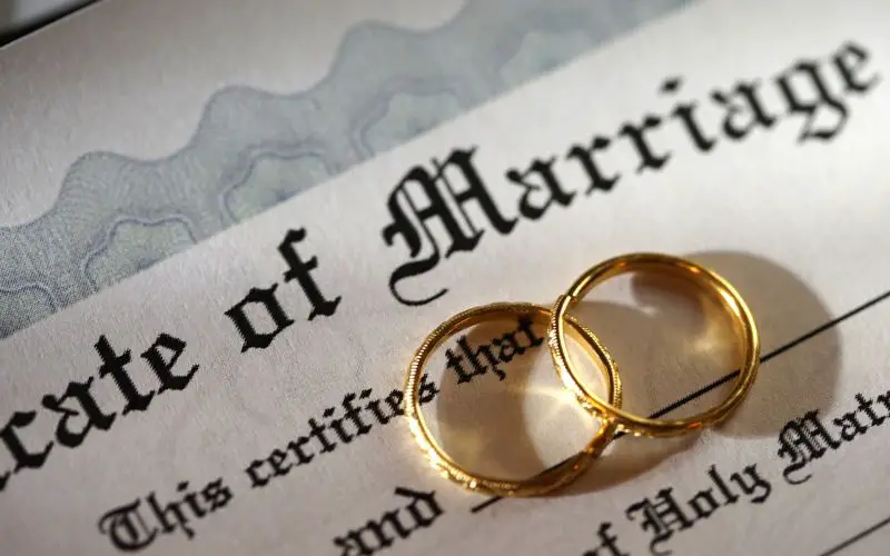 Photo showing two rings over a marriage certificate