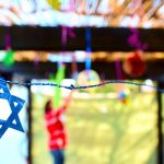 Jewish family decorating Sukkah for the Jewish festival of Sukkot_What Is European Jewish on Ancestry DNA