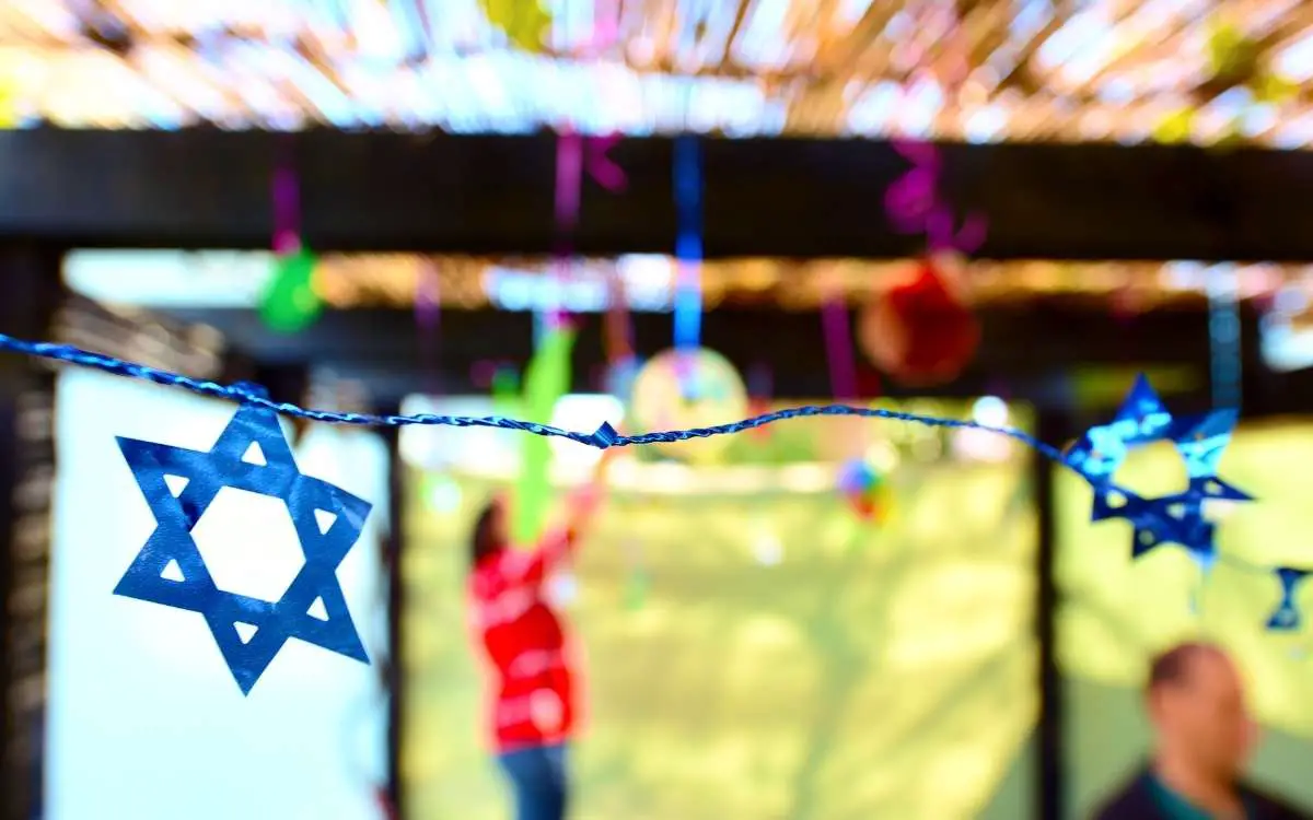 Jewish family decorating Sukkah for the Jewish festival of Sukkot_What Is European Jewish on Ancestry DNA